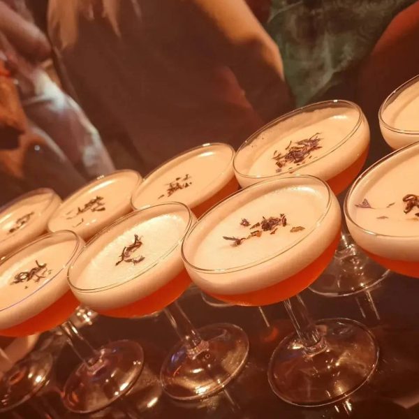 Cocktails with frothy tops arranged in rows