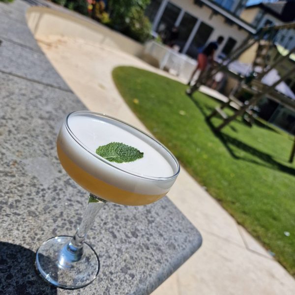 Cocktail drink with mint leaf outdoors setting