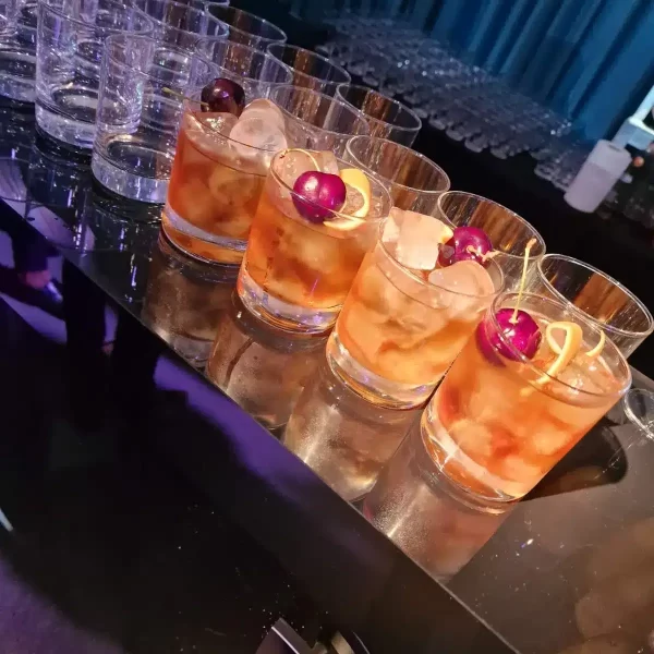 Delicious cocktails with ice and garnishes served.